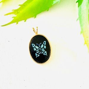 Gold and Black Pendant with Blue Butterfly Design